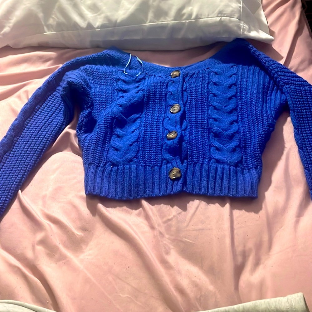 Cute blue sweater! It was worn once and there is a small hole in the arm!